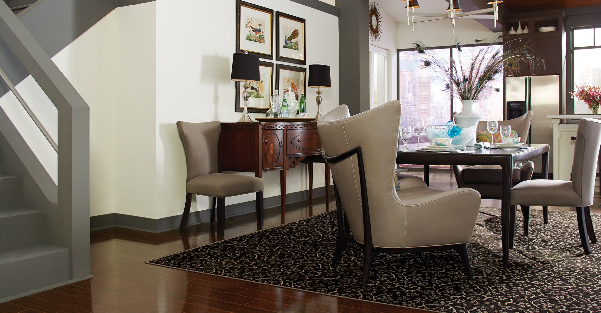 Luxurious dining space showcasing glossy hardwood floors and a custom black patterned area rug. The 